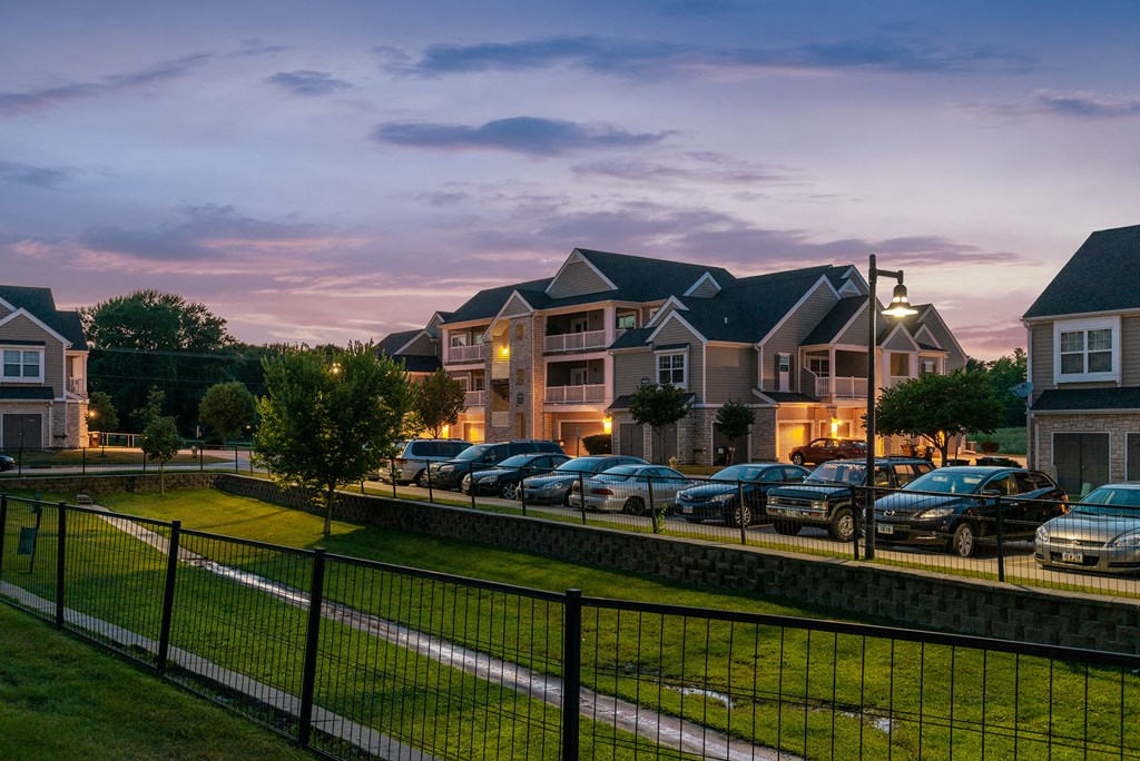 a row of homes on a city street at dusk