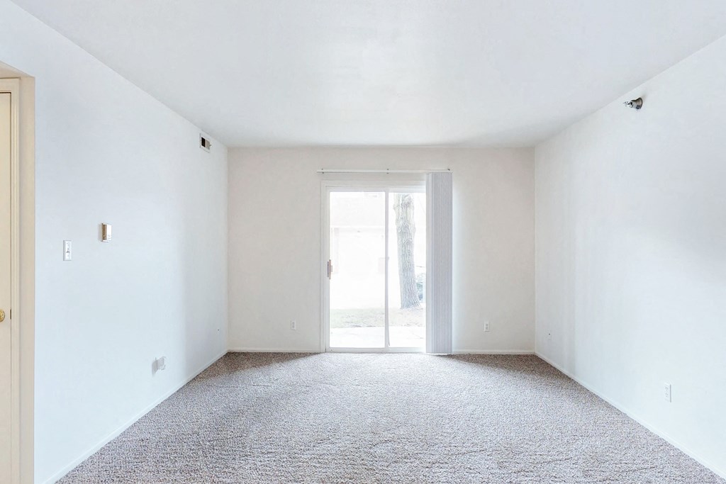 an empty room with white walls and a door