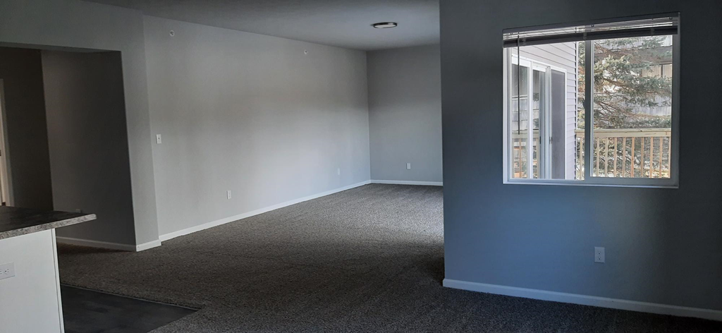 an empty living room with a large window