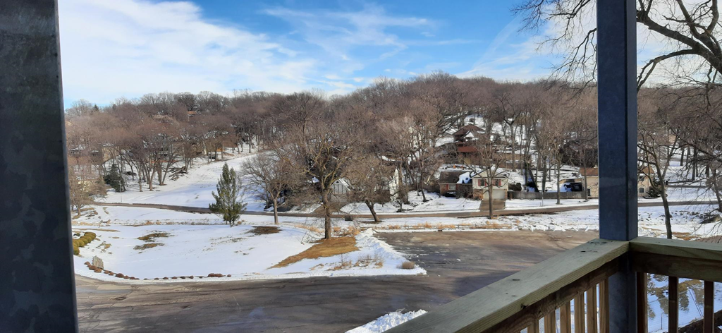 the view from the deck of a house in the snow