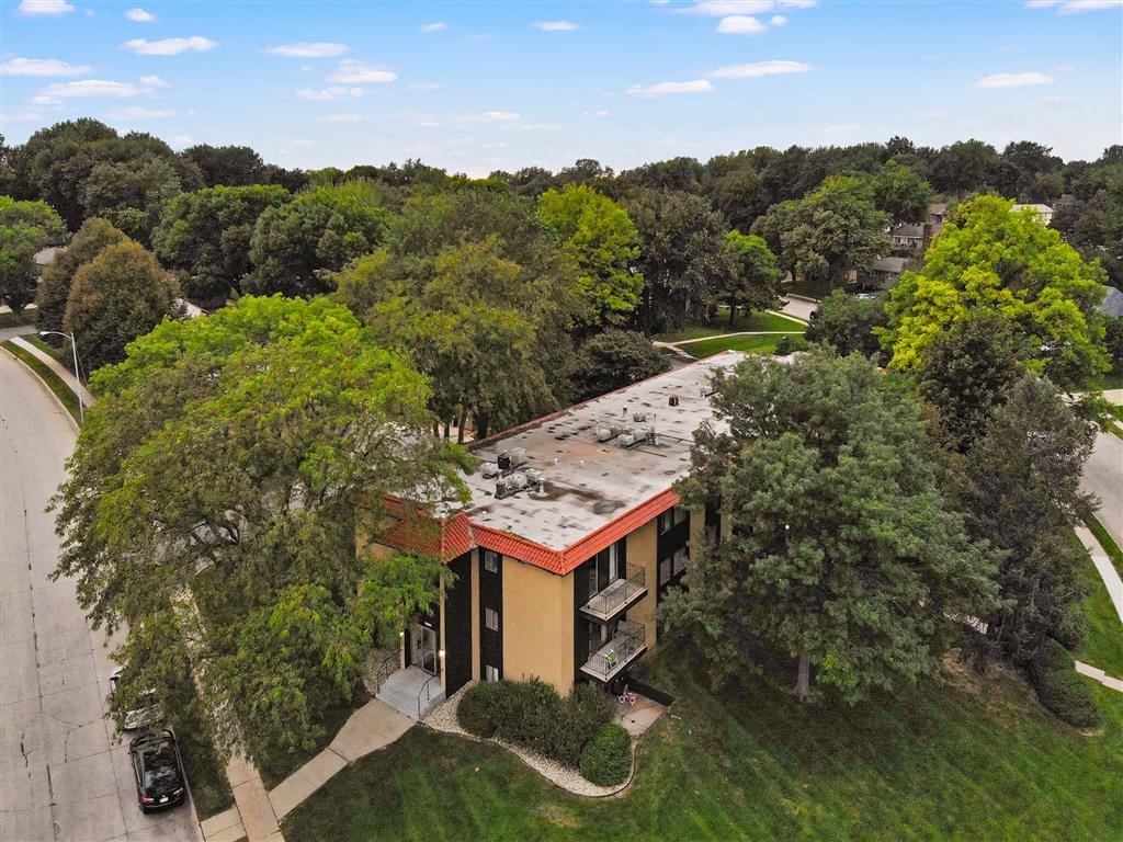 an aerial view of a building surrounded by trees