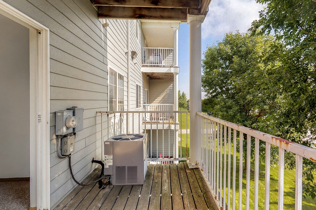 the view from the deck of a home with a heater on the porch
