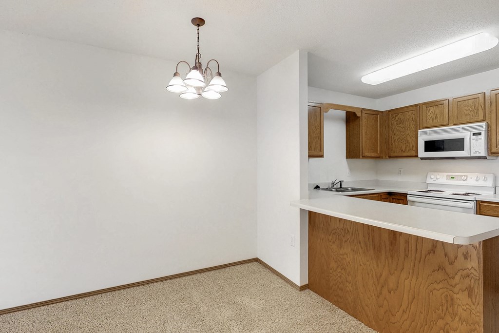 a kitchen with a counter top and a microwave and a sink