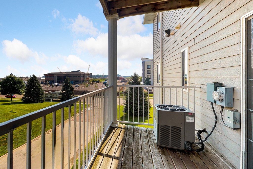 the deck of a house with an air conditioning unit on it