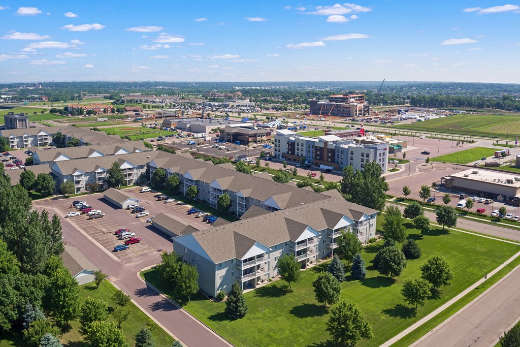 an aerial view of an apartment complex with a city in the background