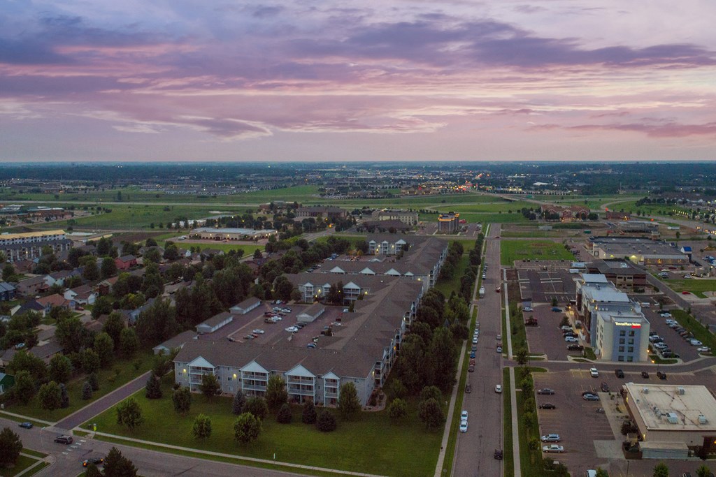 an aerial view of a suburb of a city with houses and a parking lot