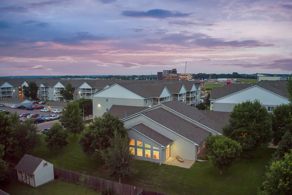 an aerial view of a building with a sunset in the background