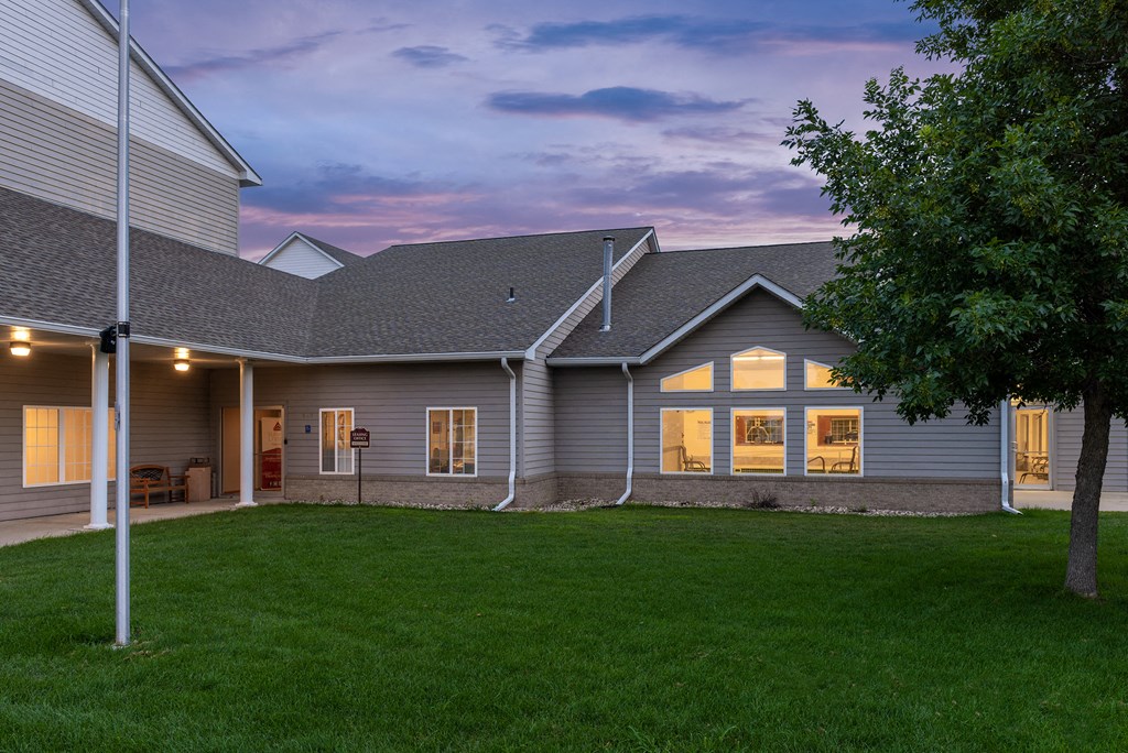 a view of a house from the back yard at dusk