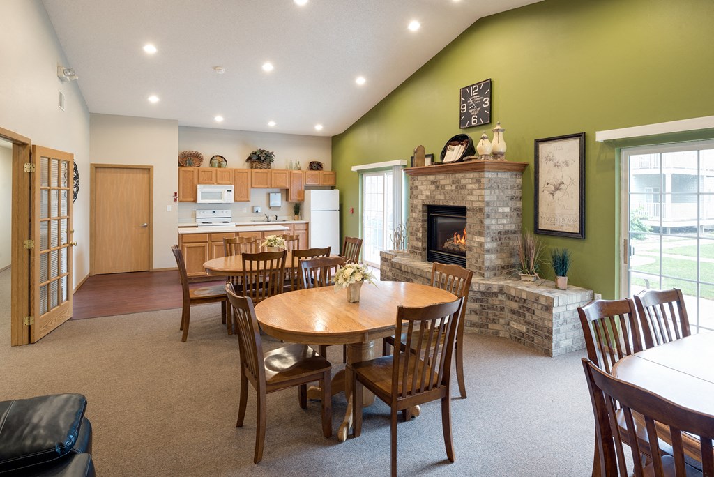 the dining room and living room with a fireplace and a table and chairs