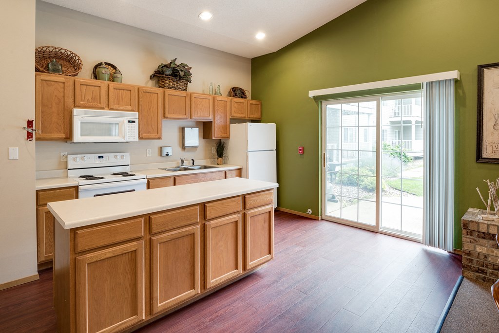 a kitchen with green walls and a door to a patio