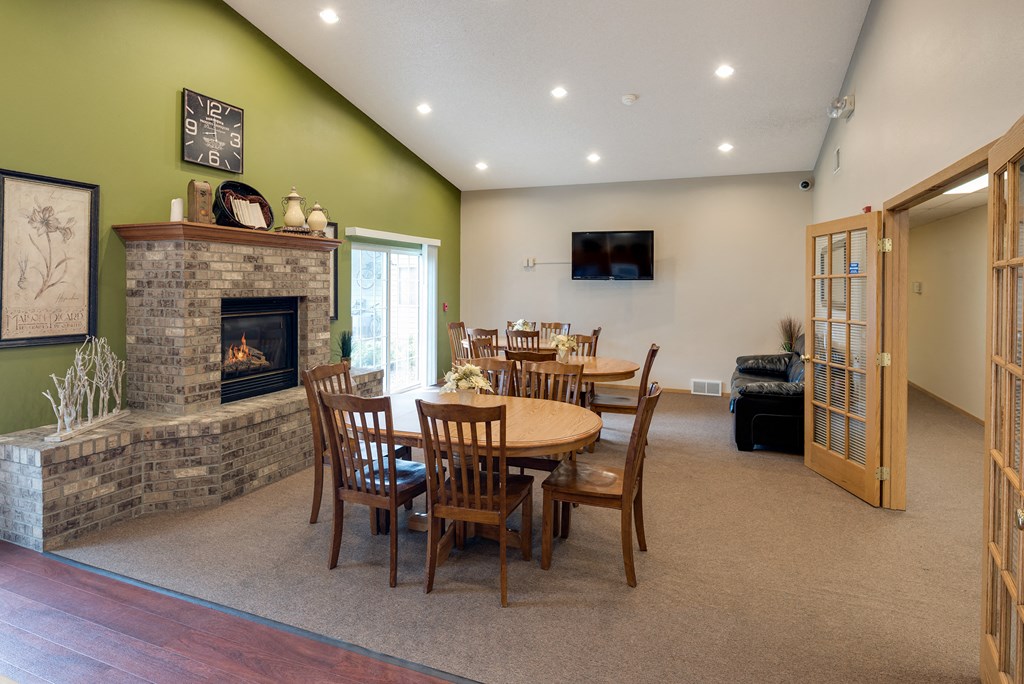 a dining room with a table and a fireplace