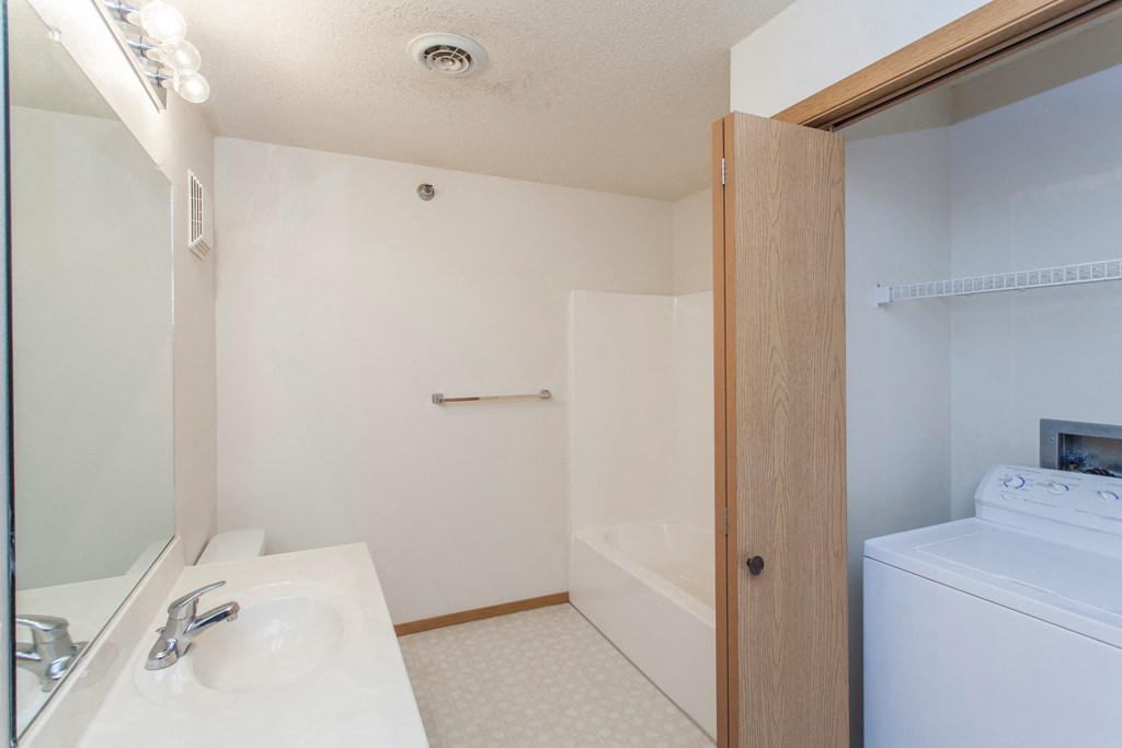 a bathroom with a sink and a shower and a toilet