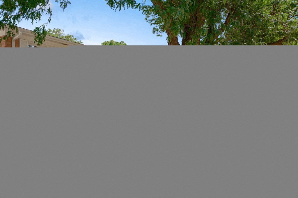 a roof of a house with trees in the background