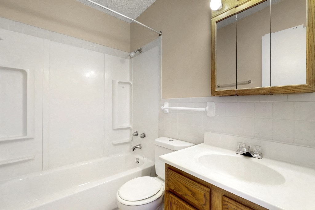 a bathroom with a sink toilet and a bath tub