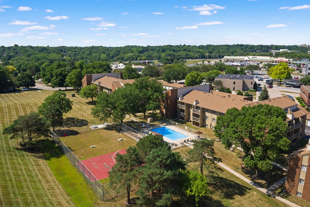 an aerial view of a neighborhood with buildings and a swimming pool