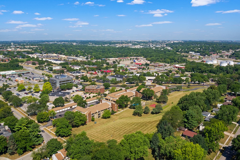 an aerial view of a city with trees and buildings