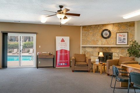 a living room with a fireplace and a door to a swimming pool