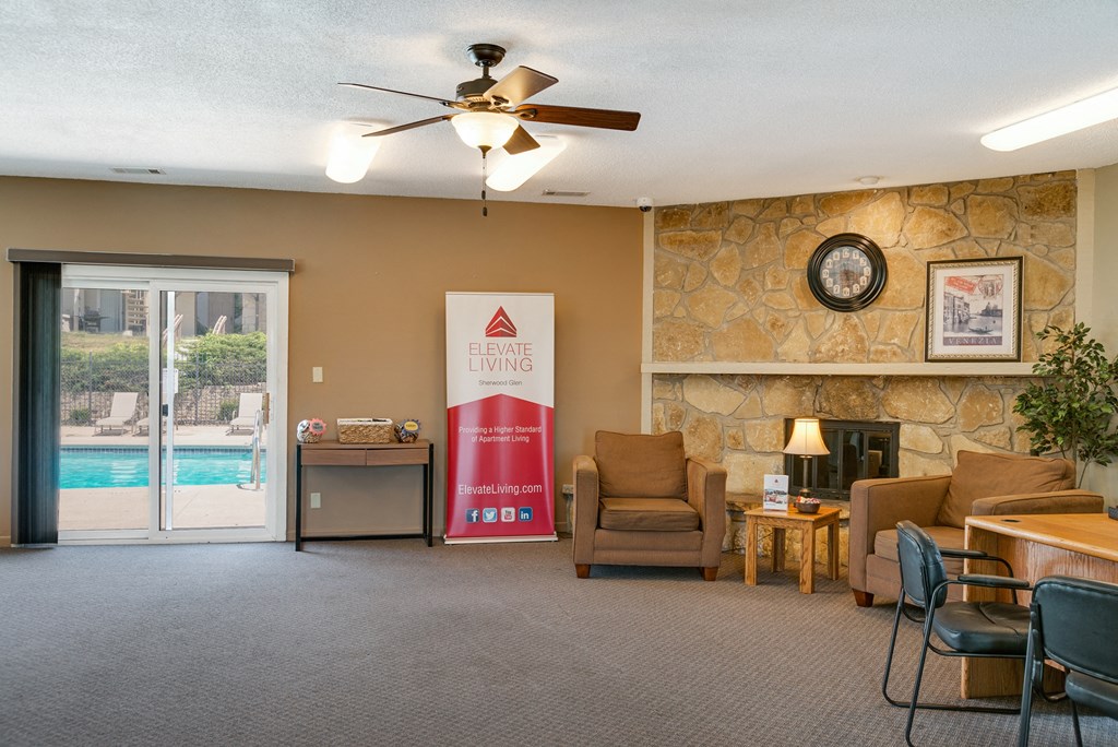 a living room with a fireplace and a door to a swimming pool