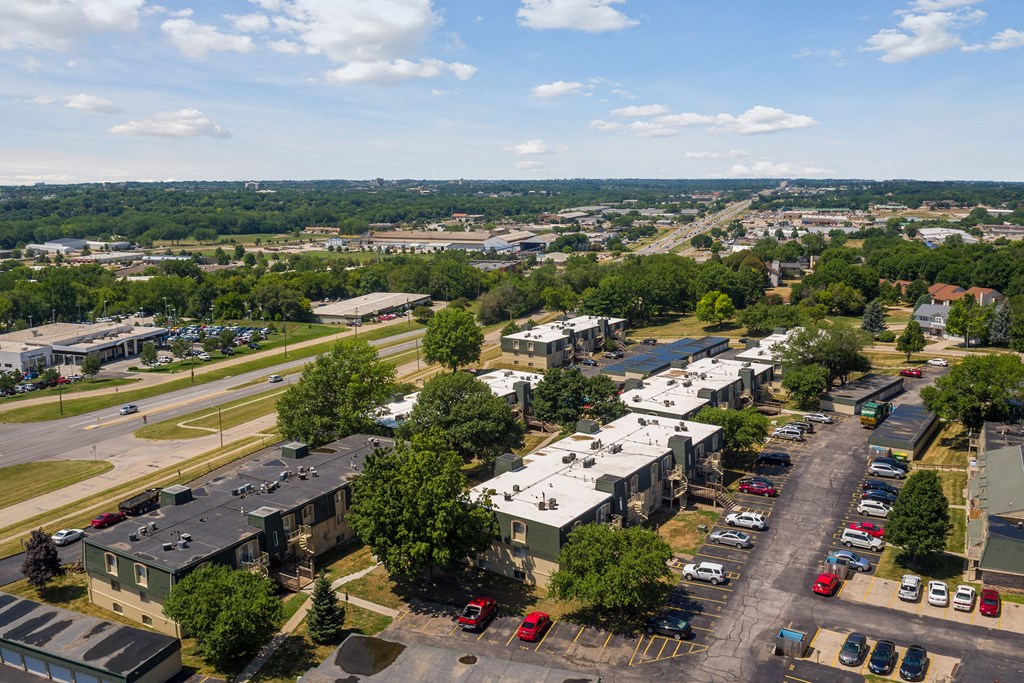 an aerial view of a city with houses and cars
