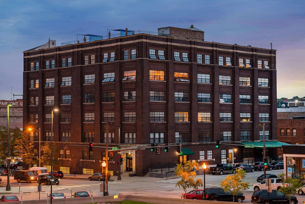 a large brick building on a city street at dusk