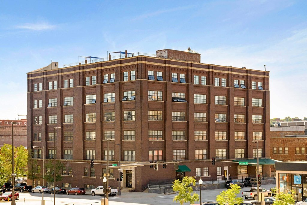 a large brick building on the corner of a city street