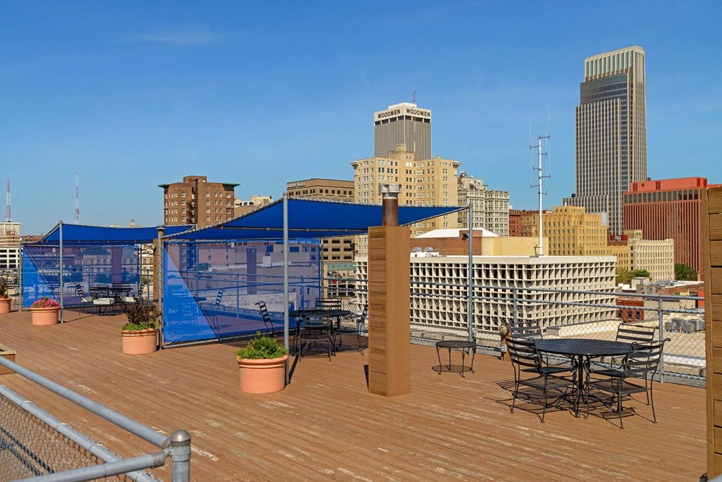 a roof top patio with a view of the city