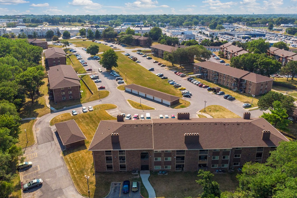 an aerial view of a college campus with cars parked in a parking lot
