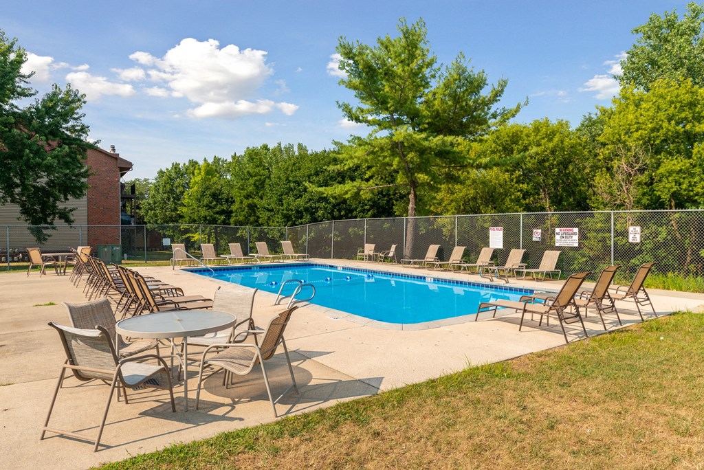 our apartments have a resort style pool with chairs and tables