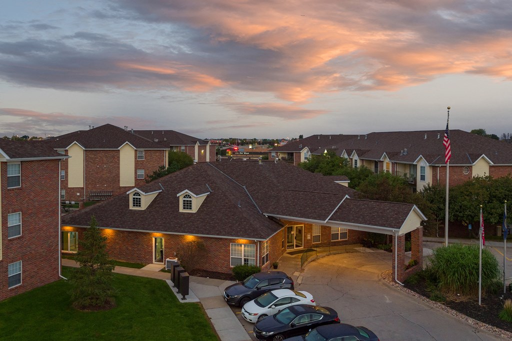 an aerial view of a building with cars parked in front of it