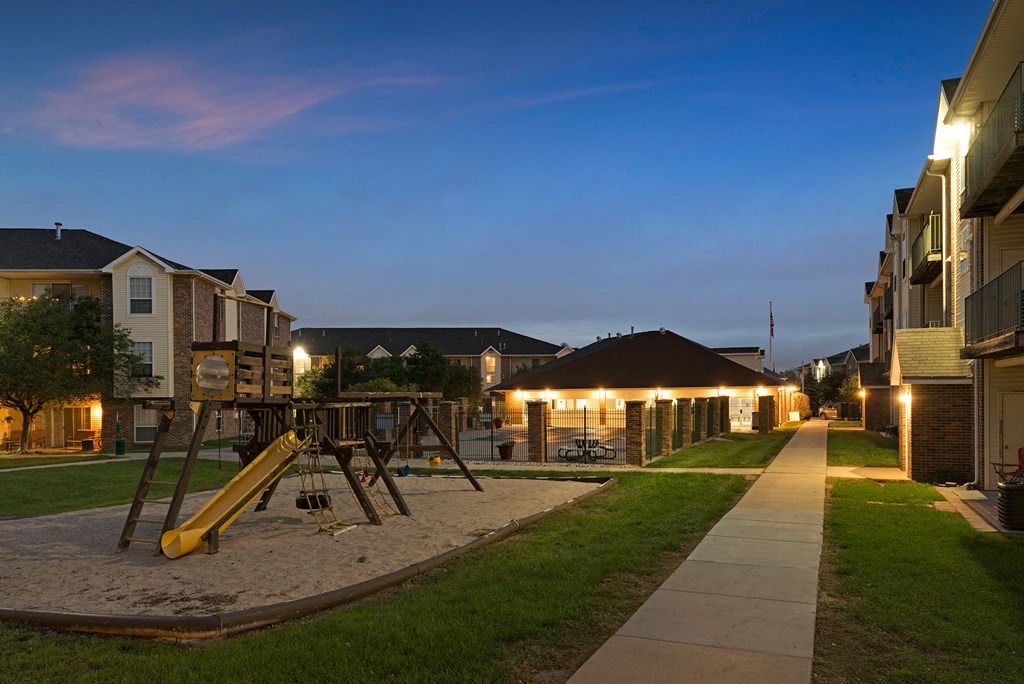 an empty playground in the middle of a neighbourhood at night