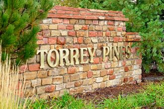 a stone sign that reads tower pine on a brick wall