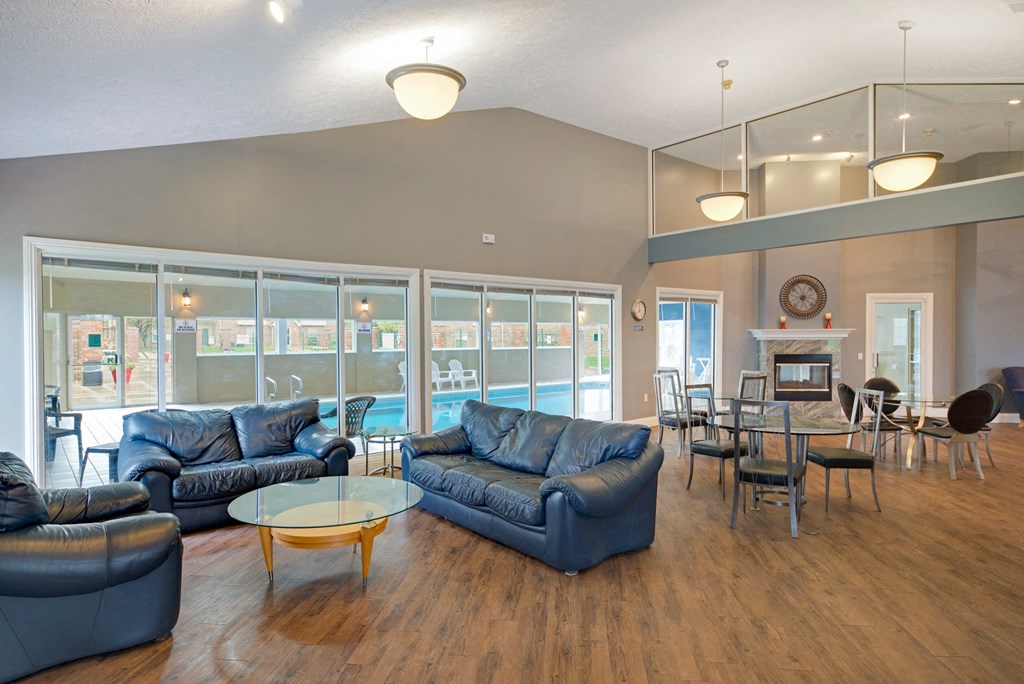 a living room and dining room with couches and a table