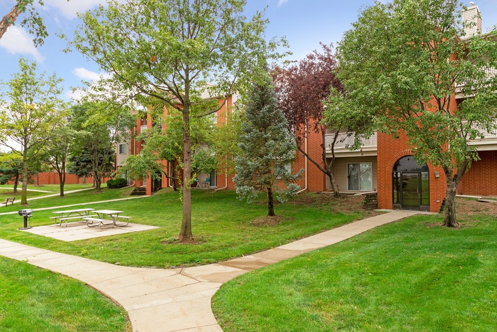 our apartments have a spacious courtyard with trees and a picnic table