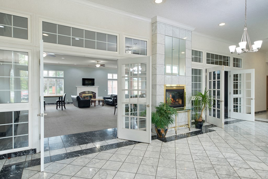 a large living room with a fireplace and glass doors