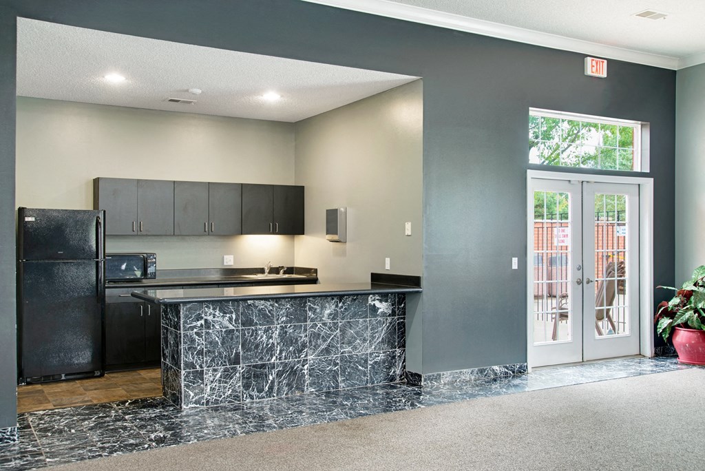 a kitchen with a counter and a door to a patio