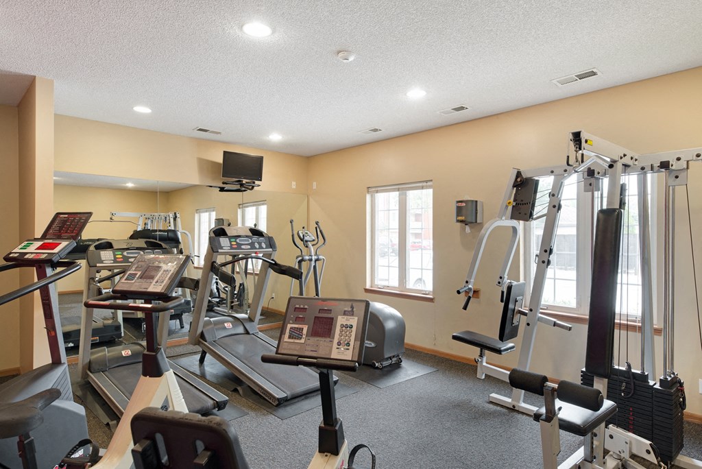 the gym at the village on spring lake apartments wi