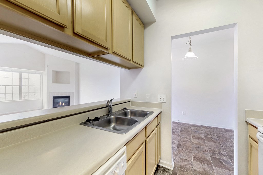 an empty kitchen with a sink and a window