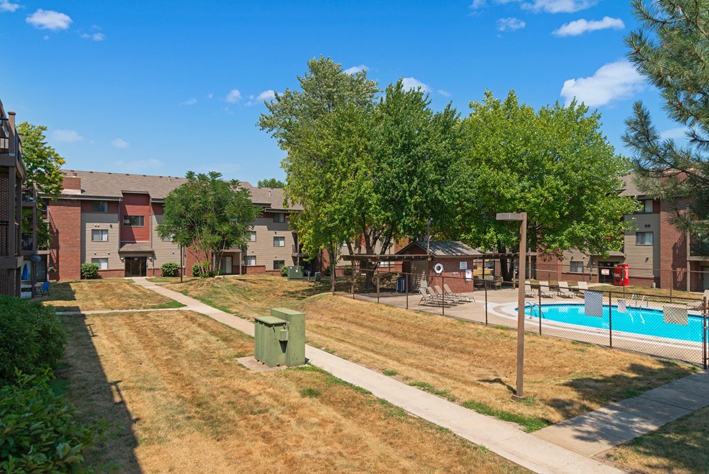 our apartments offer a swimming pool and grassy area with trees