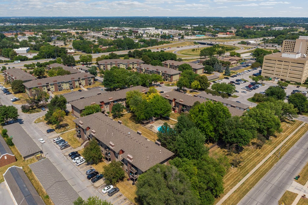 an aerial view of a parking lot and buildings in a city