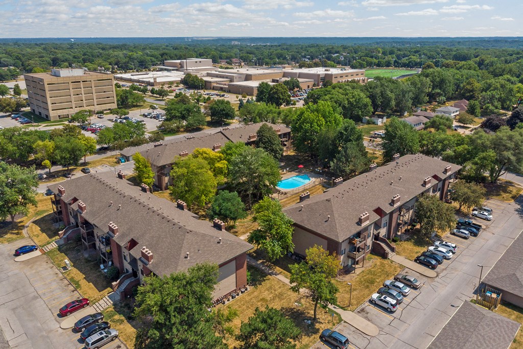 a view of a building from above with a parking lot