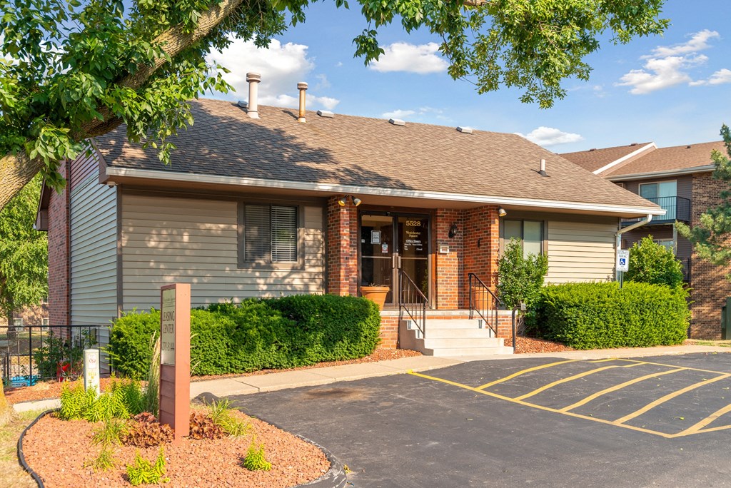 the front of a house with a driveway and stairs