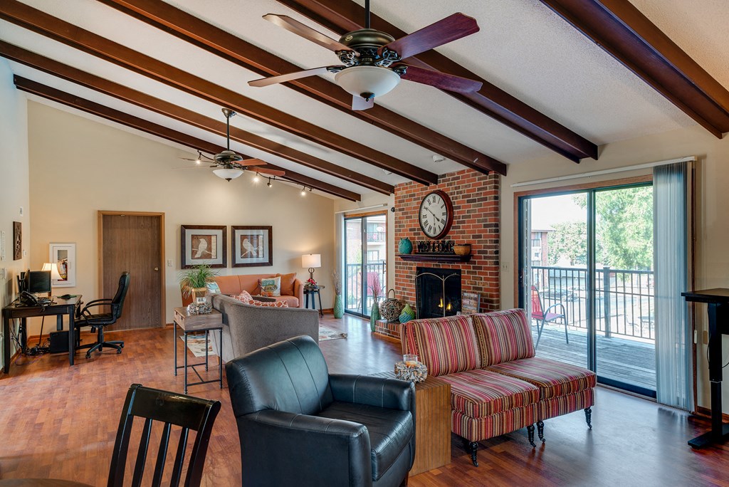 a living room with a fireplace and a ceiling fan