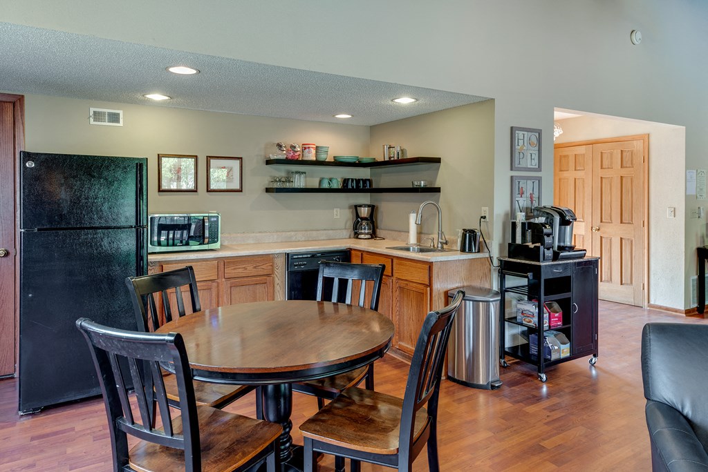 a kitchen and dining area with a table and chairs