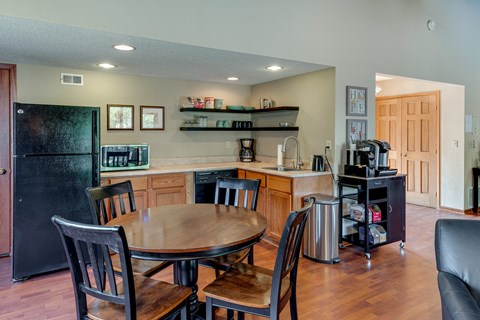 a kitchen and dining area with a table and chairs