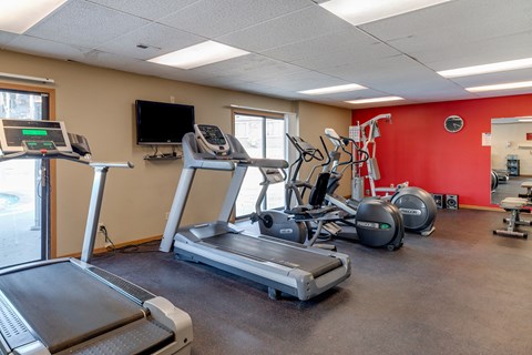 the gym with treadmills and other exercise equipment at our apartments