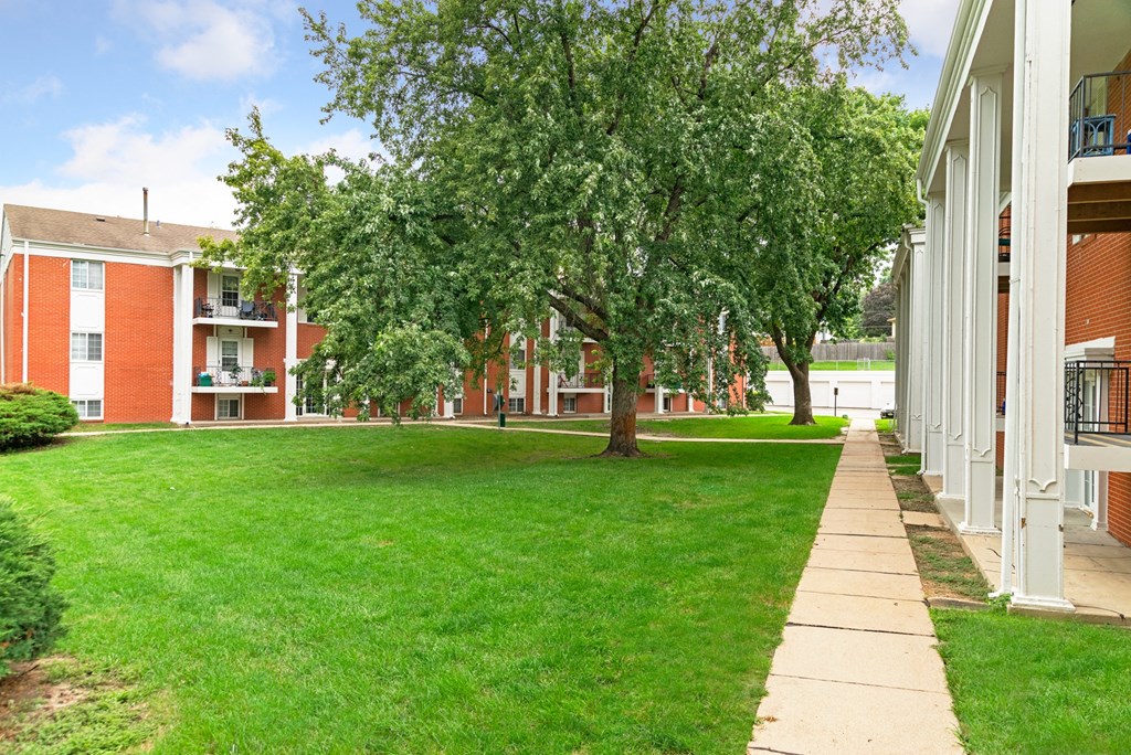 our apartments offer a green lawn and trees for residents to enjoy
