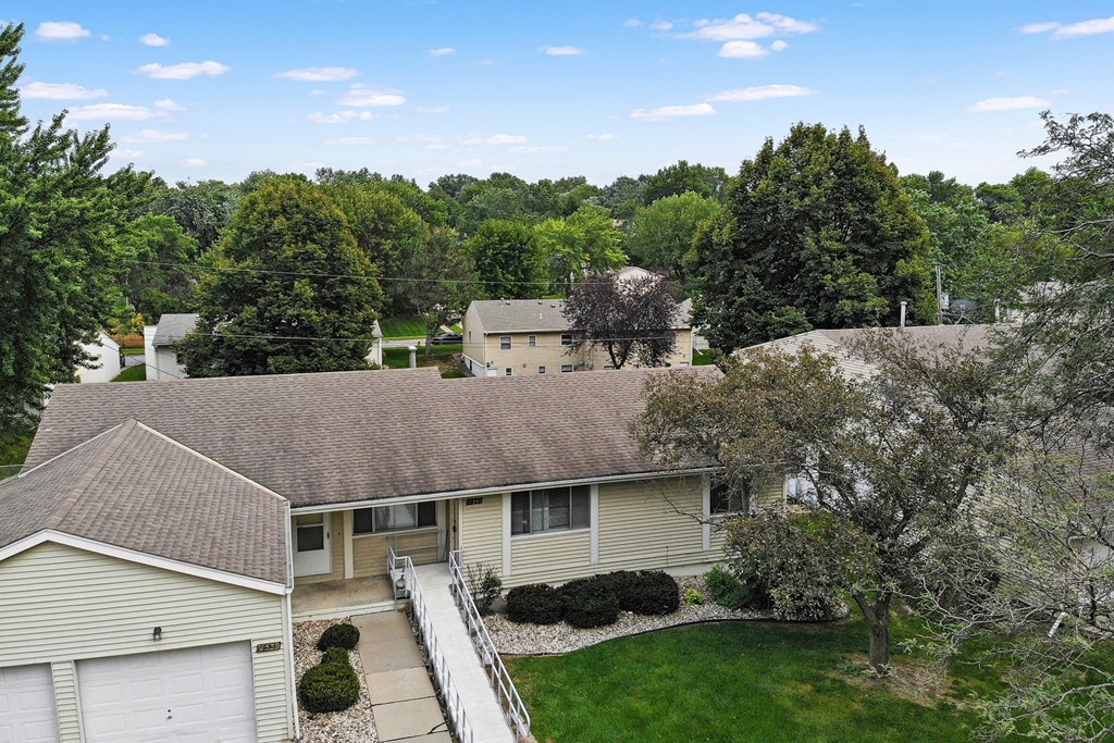 an aerial view of a house with a yard and trees