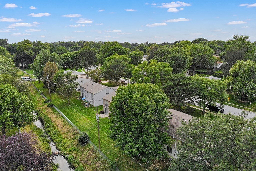 a view of the neighborhood from above with houses and trees