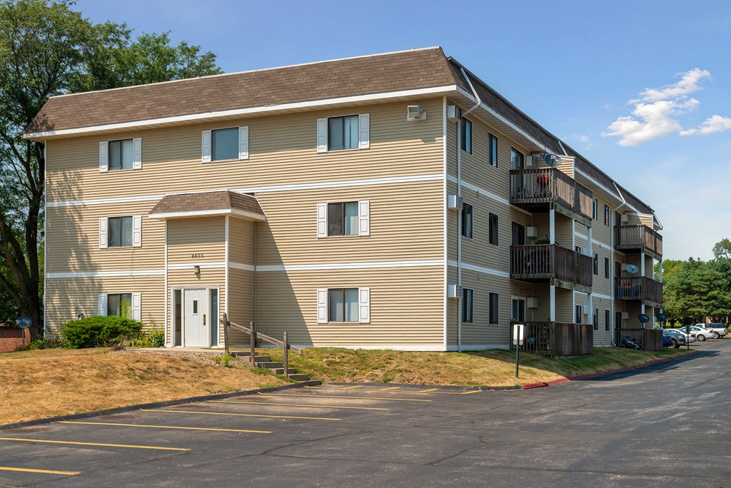 a large apartment building with a street in front of it