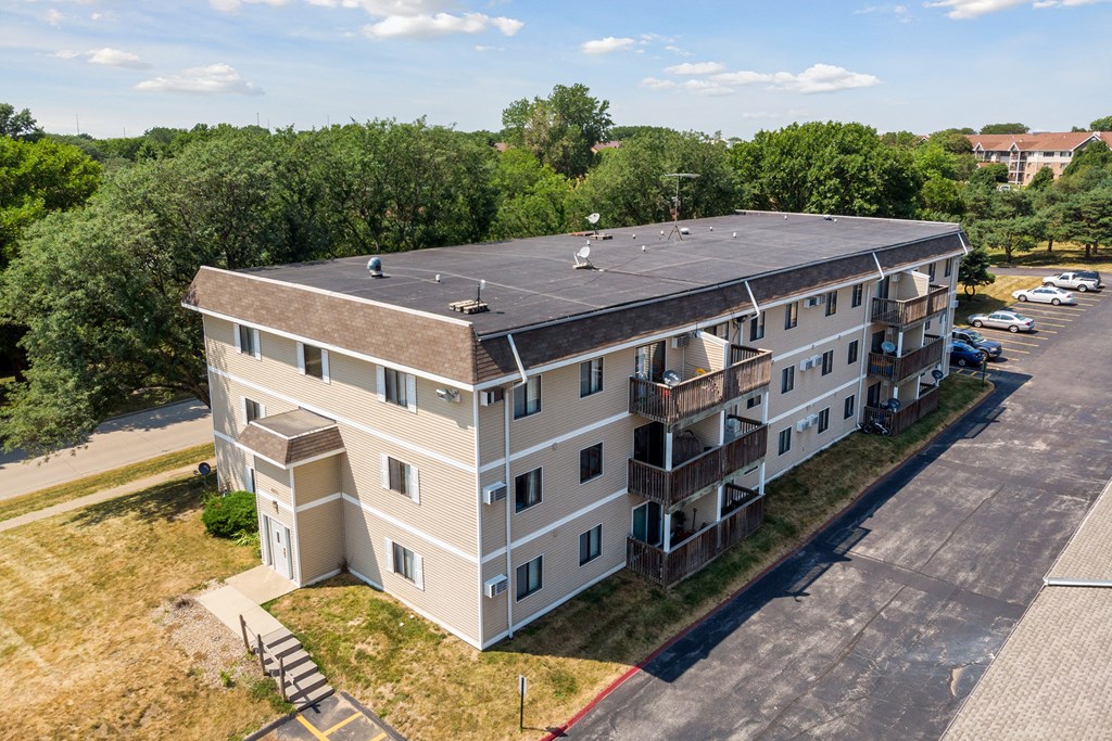 an aerial view of an apartment building with a rooftop solar system